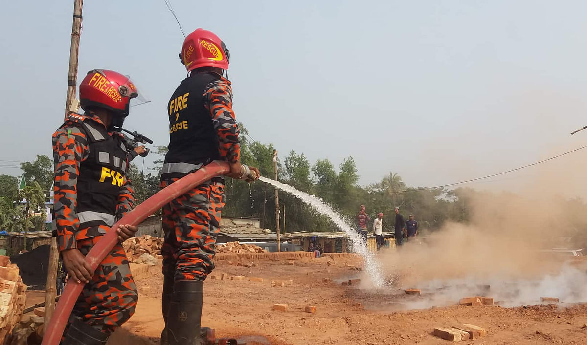 Fire service men douse the fire at a brick kiln after it was fined by the environment department at Hajiganj, Chandpur on 20 January 2020. Photo: Alam Palash