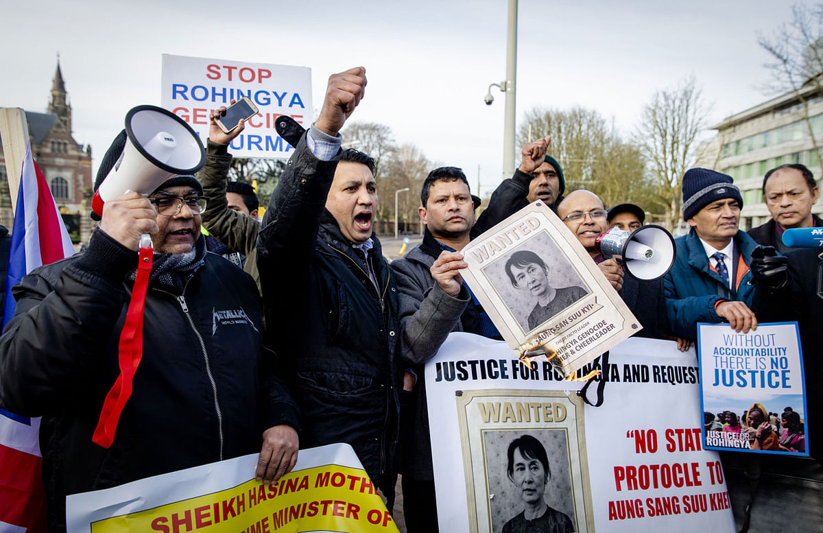 In this file photo taken on 10 December 2019 protesters holds portraits of Myanmarese government leader Aung San Suu Kyi as they take part in a demonstration in support to the Rohingya Muslim minority in front of the Peace Palace in The Hague, during the start of a three-day hearing on Rohingya genocide case at the UN`s International Court of Justice. Photo: AFP