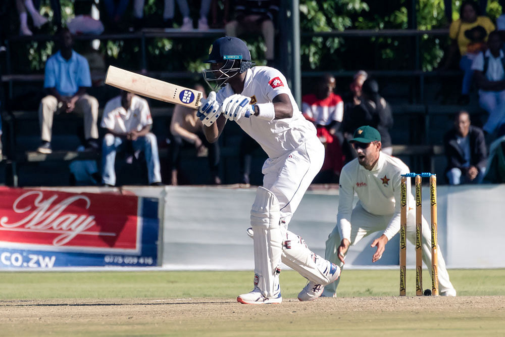 Sri Lanka batsman Angelo Mathews (C) is in action as slip fielder Craig Ervine looks on during the third day of the first Test cricket match at the Harare Sports Club in Harare on 21 January 2020. Photo: AFP