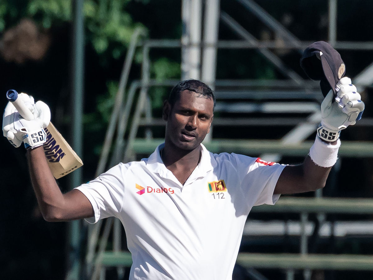 Sri Lanka`s batsman Angelo Mathews (C) celebrates reaching 200 runs during the fourth day of the first Test cricket match between Zimbabwe and Sri Lanka at the Harare Sports Club in Harare on January 22, 2020. / AFP