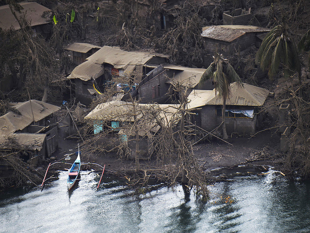 A bird`s eye view of mud-covered houses at the foot of Taal volcano as seen from a Philippine airforce helicopter during an aerial survey on 21 January 2020. Photo: AFP