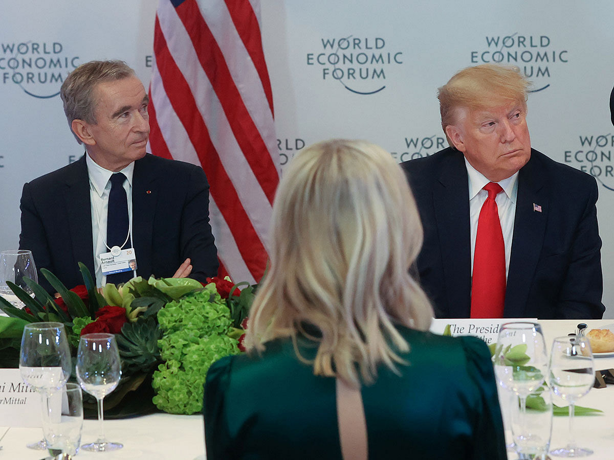 LVMH CEO Bernard Arnault sits with US president Donald Trump during a dinner for corporate chief executives alongside the World Economic Forum in Davos, Switzerland on 21 January 2020. Photo: Reuters