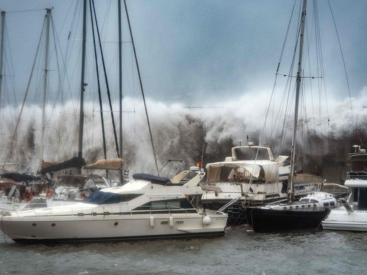 Big waves overpass a breakwater at the Port Olympic marina in Barcelona as storm Gloria batters Spanish eastern coast on 21 January 2020. Photo: AFP