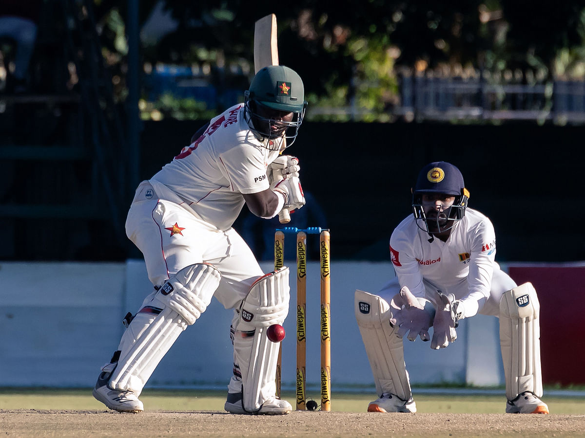 Zimbabwe`s batsman Prince Masvaure (L) prepares to hit the ball past wicket keeper Niroshan Dickwella looks on during the fourth day of the first Test cricket match played between Zimbabwe and Sri Lanka at the Harare Sports Club in Harare on 22 January, 2020. Photo: AFP