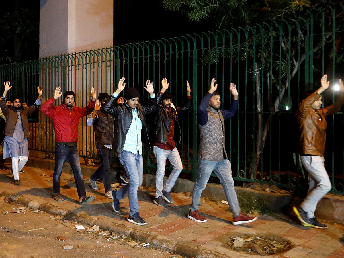 Students raising their hands leave the Jamia Milia University following a protest against a new citizenship law, in New Delhi, India, on 15 December 2019. Reuters File Photo