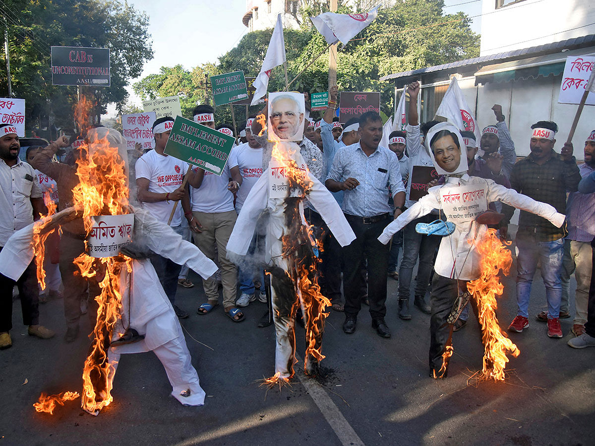 File picture of activists from the All Assam Students Union (AASU) burning effigies depicting India`s home minister Amit Shah, prime minister Narendra Modi and chief minister of Assam Sarbananda Sonowal during a protest against the Citizenship Amendment Bill, a bill approved by India`s cabinet to give citizenship to religious minorities persecuted in neighboring Muslim countries, in Guwahati, India, on 4 December 2019. Reuters File Photo