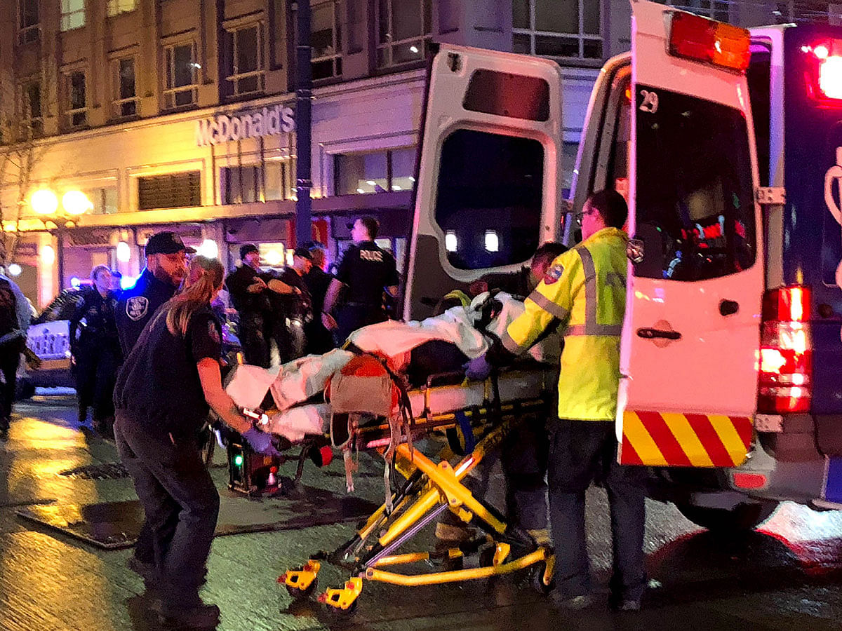 EMT and Police give first aid to a shooting victim in downtown on 22 January in Seattle, Washington. Photo: AFP