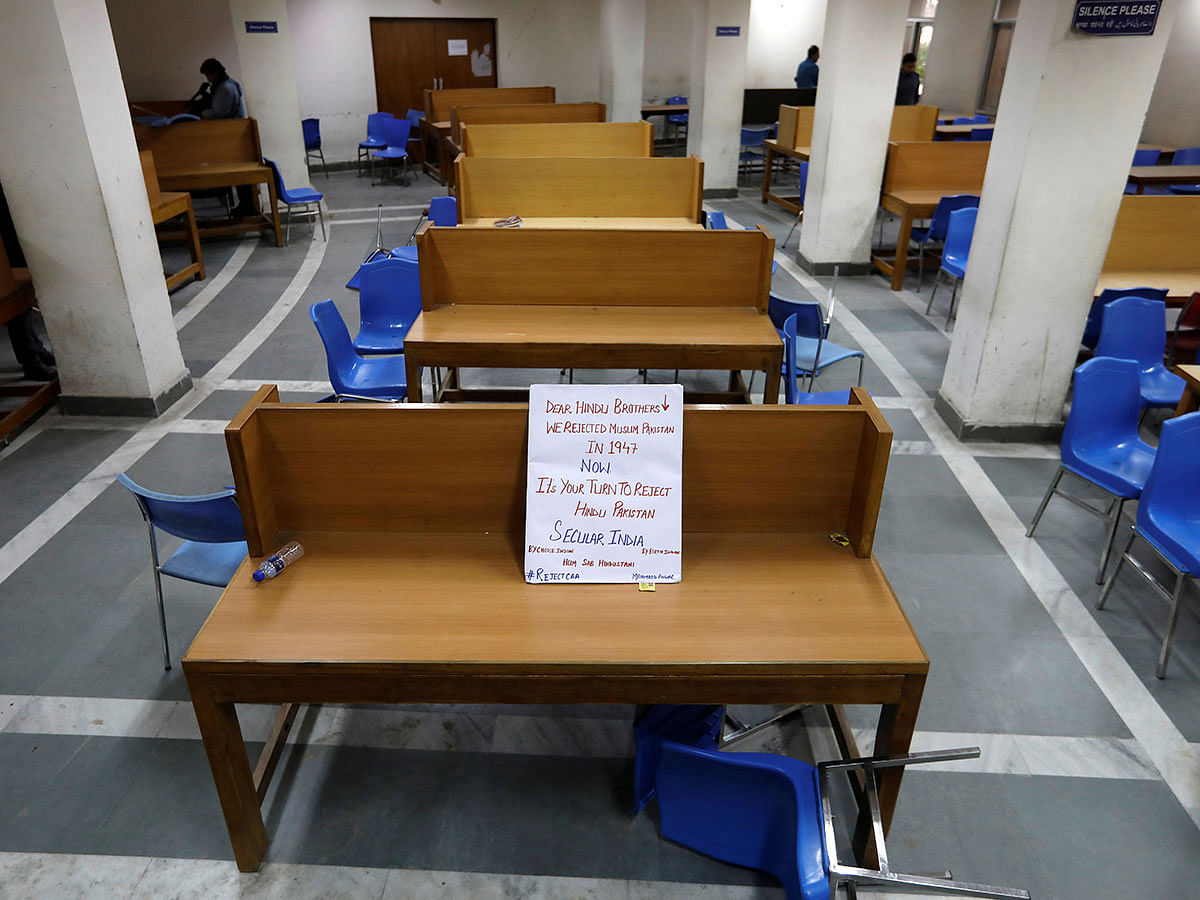 A placard lies on a table inside a partially damaged library of the Jamia Millia Islamia university after police entered the university campus on the previous day, following a protest against a new citizenship law, in New Delhi, India, on 16 December 2019. Reuters File Photo