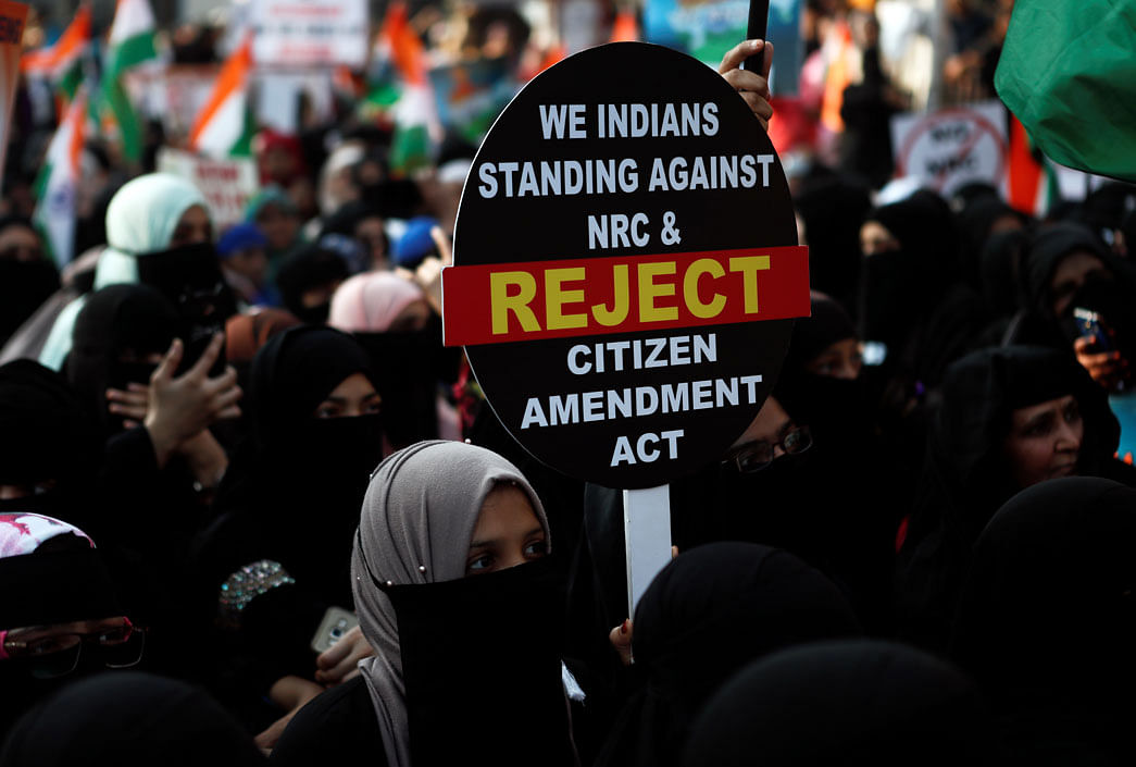 Demonstrators hold a placard during a protest against a new citizenship law in Mumbai, India, on 21 January 2020. Photo: Reuters