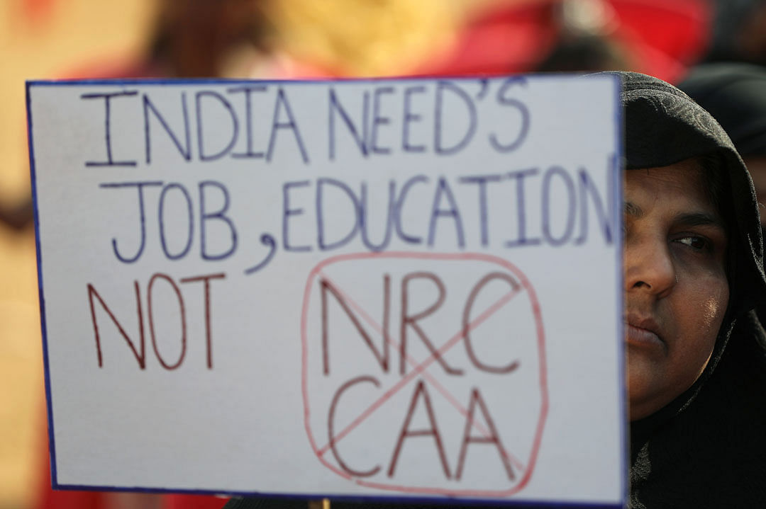 A woman holds a placard during a protest against a new citizenship law in Mumbai, India, on 18 January 2020. Photo: Reuters