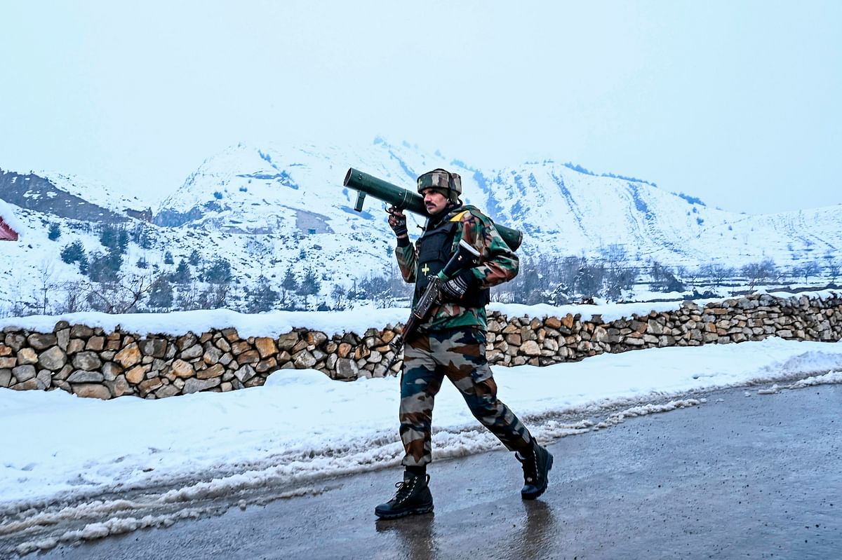 A security personnel walks on a road as he patrols near a site of a gunbattle between suspected militants and government forces at Khrew area of Pampore in Pulwama district, south of Srinagar on 21 January 2020. Photo: AFP