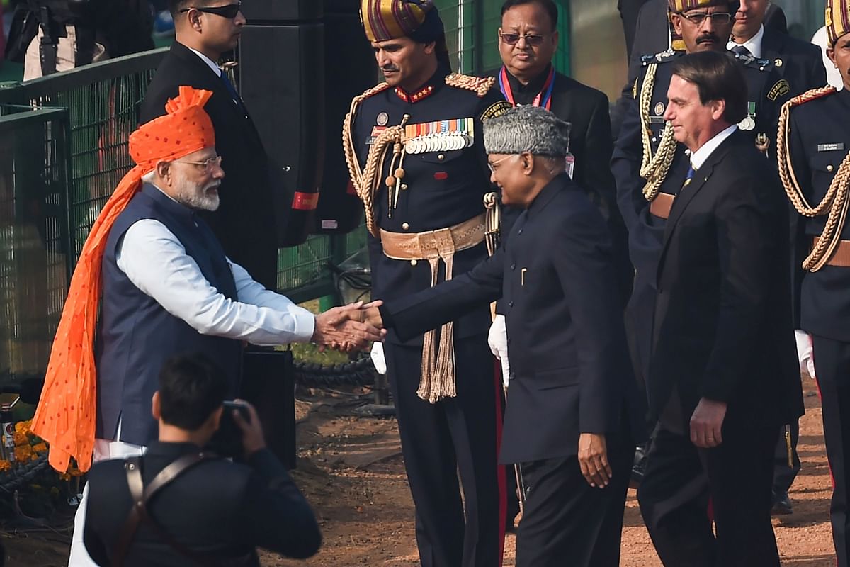 India`s prime minister Narendra Modi (L) greets President Ram Nath Kovind (C) and Brazil`s President Jair Bolsonaro (R) as they arrive to attend the Republic Day parade in New Delhi on 26 January 2020. Photo: AFP