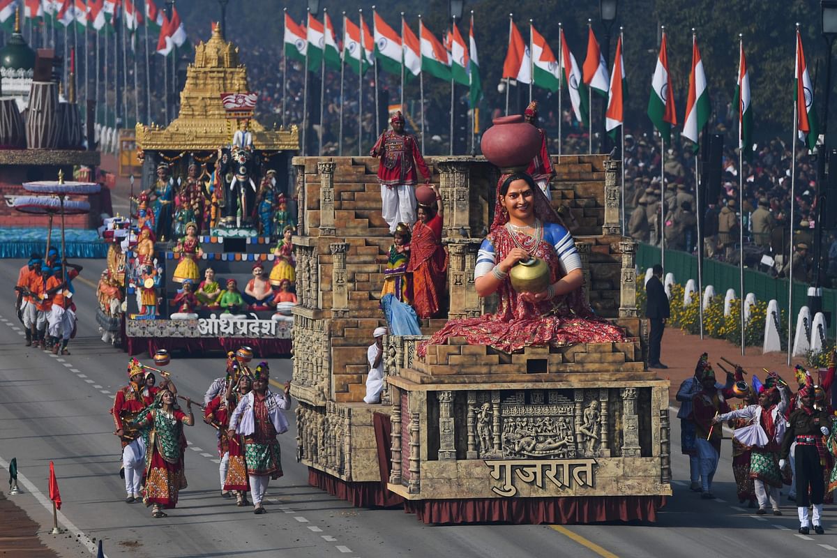 Participants walk next to floats along Rajpath during the Republic Day parade in New Delhi on 26 January 2020. Huge crowds gathered for India`s Republic Day parade on 26 January as women took centre stage in the annual pomp-filled spectacle of military might featuring army tanks, horses and camels. Photo: AFP