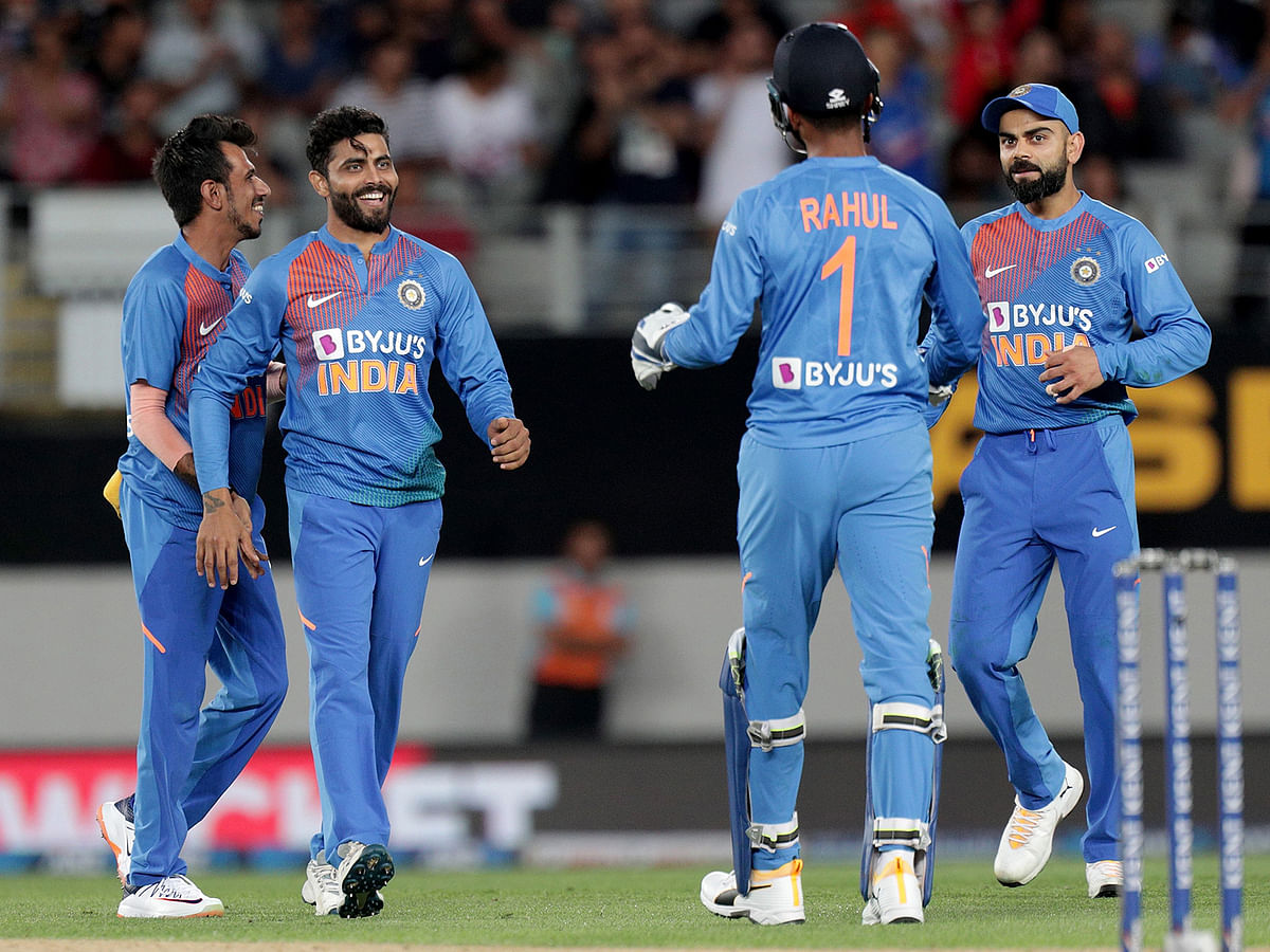 Indian players celebrate after catching out New Zealand’s Colin de Grandhomme (not pictured) during the second Twenty20 cricket match between New Zealand and India at Eden Park in Auckland on 26 January, 2020. Photo: AFP
