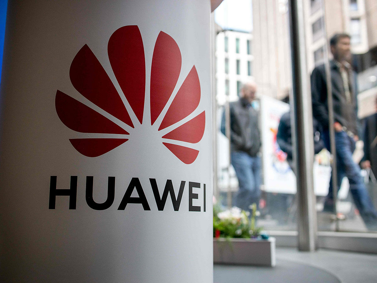 In this file photo taken on 29 April 2019, a pedestrian walks past a Huawei product stand at an EE telecommunications shop in central London on 29 April 2019. Photo: AFP