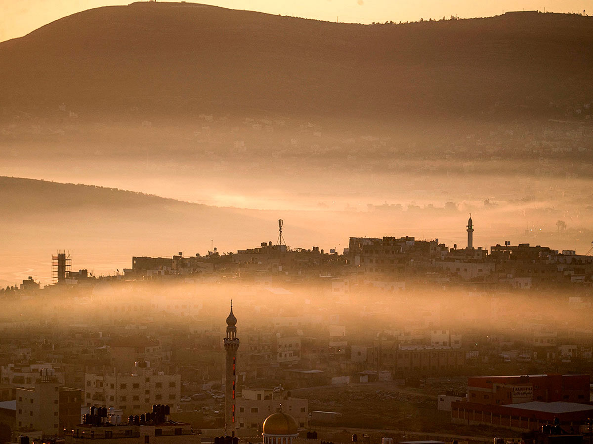 This picture taken around sunrise on 26 January 2020 from Nablus in the occupied West Bank of a general view of its eastern valley shows the Askar (foreground) Palestinian refugee camp in `Area A` of the West Bank (full Palestinian civil and security control), and Beit Fureik (background) partially between `Area B` (Palestinian civil control and joint Israeli-Palestinian security control) and `Area C` (full Israeli civil and security control). Photo: AFP