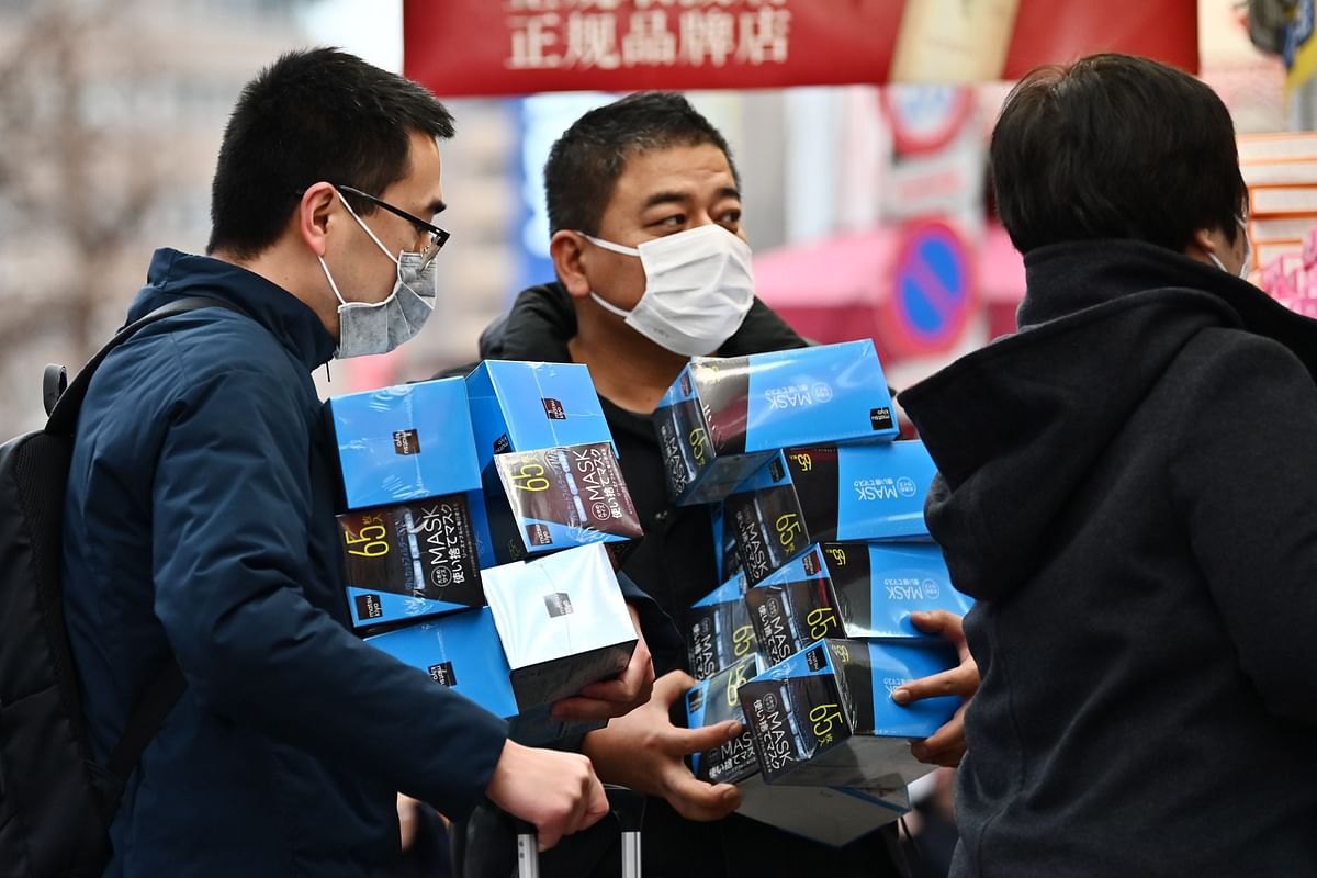 Customers buy face masks from a drugstore in Tokyo`s Akihabara area on 27 January. Photo: AFP