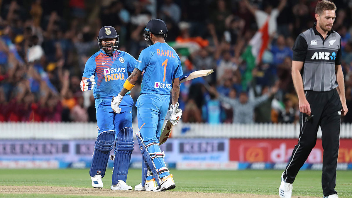India’s Rohit Sharma (L) celebrates with KL Rahul (C) after hitting the winning runs as New Zealand’s Tim Southee (R) looks on during the third Twenty20 cricket match between New Zealand and India at Seddon Park in Hamilton on 29 January 2020. Photo: AFP