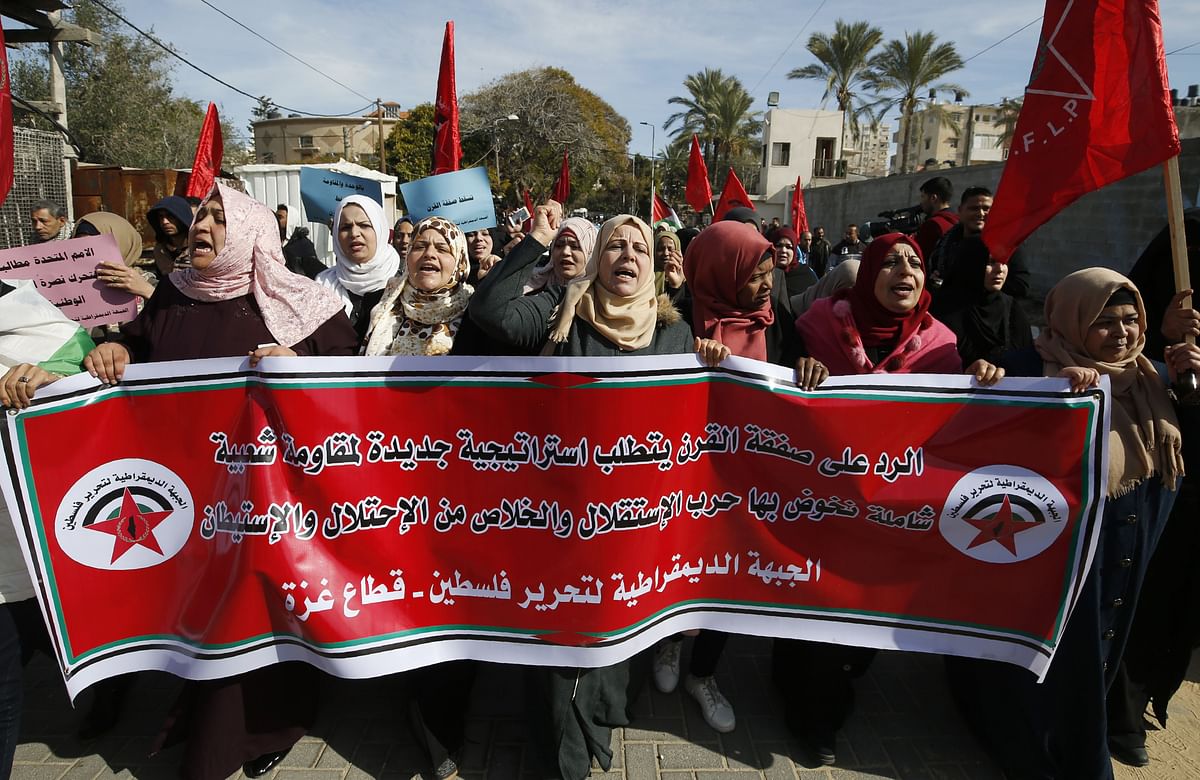 Palestinian demonstrators carry a banner from Gaza`s Democratic Front for the Liberation of Palestine group denouncing the latest Middle East peace plan by US president Donald Trump, on 27 January in Gaza City. Photo: AFP