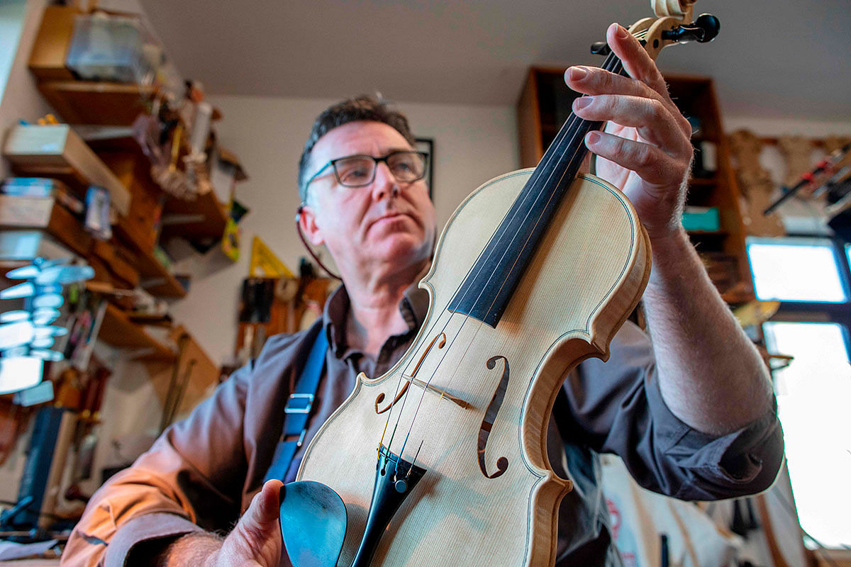 Violin-maker Martin McLean works in his workshop near Cookstown, County Londonderry, Northern Ireland on 22 January. Photo: AFP