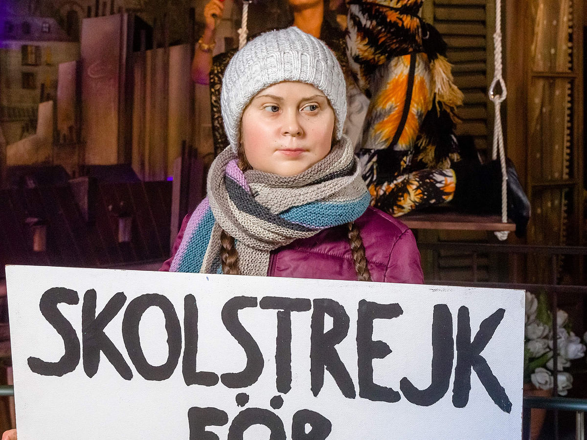 A picture taken on 29 January, 2020 shows a detail of a wax figure bearing Swedish teen climate activist Greta Thunberg with a placard reading `the school strike for the climate` (in Swedish Skolstrejk för klimatet) during its presentation at the Panoptikum waxworks museum in Hamburg, northern Germany. Photo: AFP