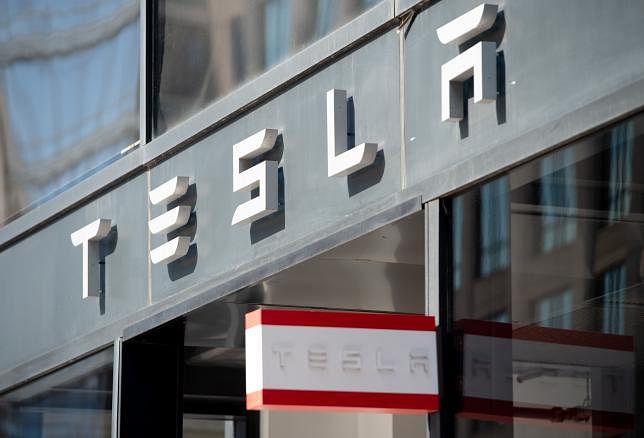 In this file photo taken on 8 August, 2018 the Tesla logo is seen outside of their showroom in Washington, DC. Photo: AFP