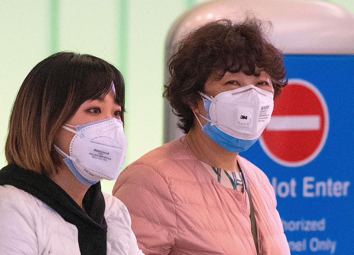 Passengers wear face masks to protect against the spread of the Coronavirus as they arrive on a flight from Asia at Los Angeles International Airport, California, on 29 January 2020. Photo: AFP
