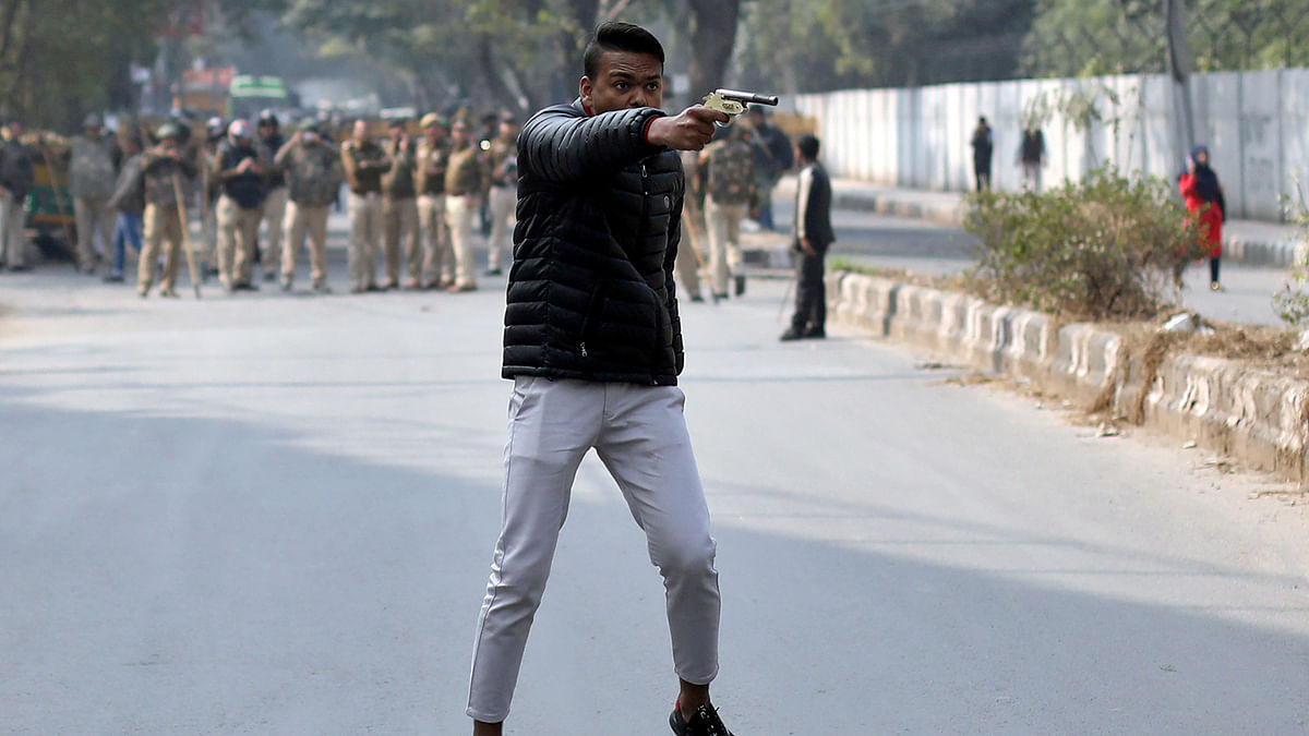 An unidentified man reacts as he brandishes a gun during a protest against a new citizenship law outside the Jamia Millia Islamia university in New Delhi, India on 30 January. Photo: Reuters
