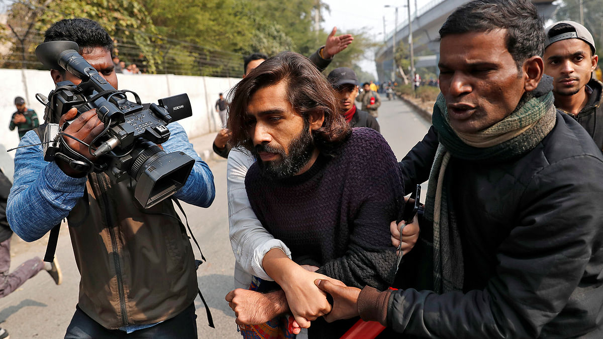 A wounded man is helped after an unidentified man opened fire during a protest against a new citizenship law outside the Jamia Millia Islamia university in New Delhi, India on 30 January. Photo: Reuters