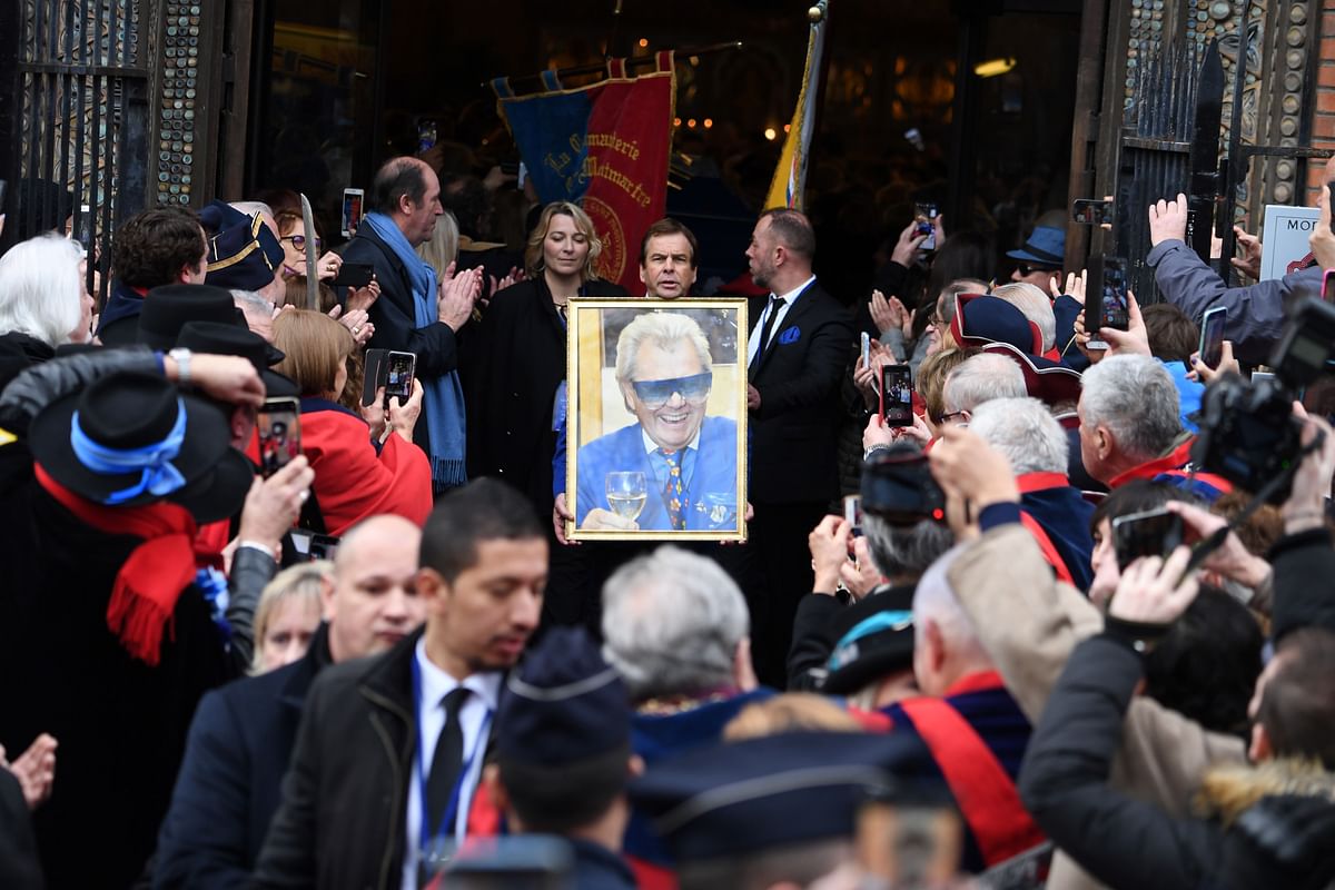 Attendees leave after the funerals of late French cabaret director Michel Georges Alfred Catty known as Michou on 31 January 2020 at Saint-Jean de Montmartre church in Paris. Michou died at age 88 on 26 January 2020. Photo: AFP