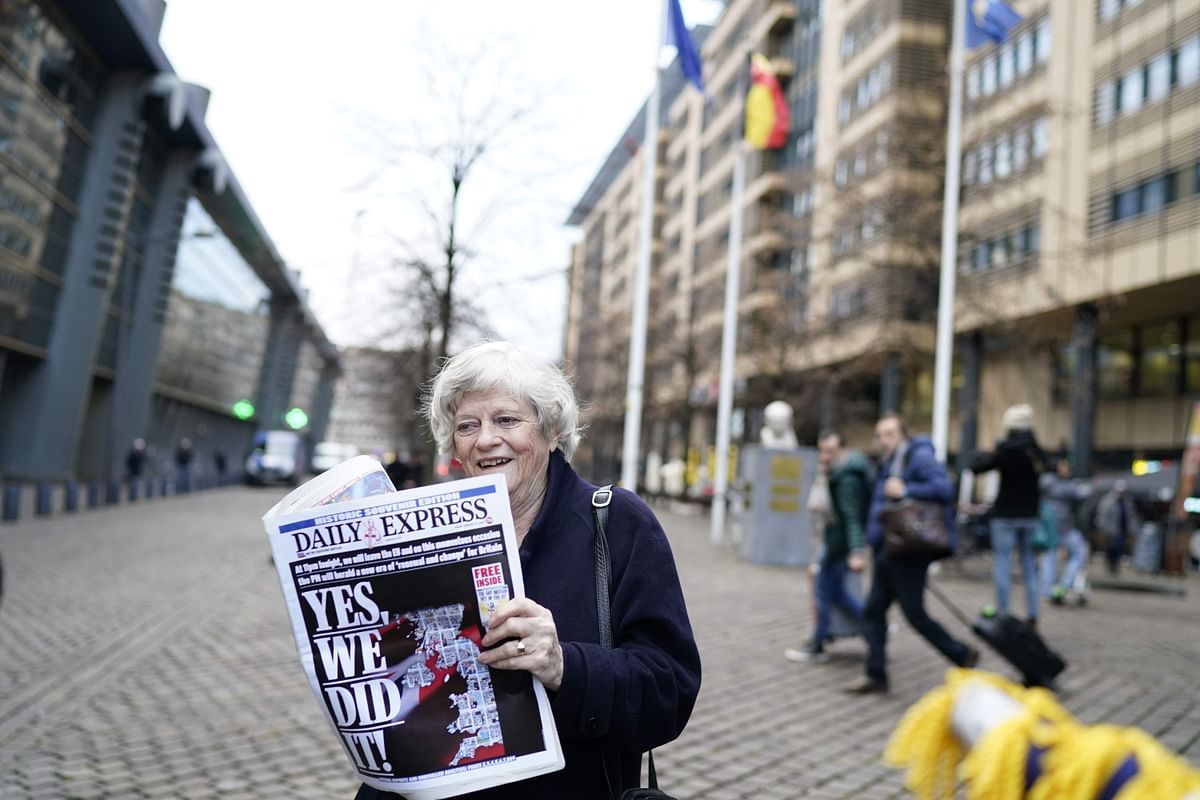 British members of the European Parliament from the Brexit Party Ann Widdecombe holds a newspaper in front of the train station as she leaves in Brussels on 31 January 2020 on the Brexit day. Photo: AFP