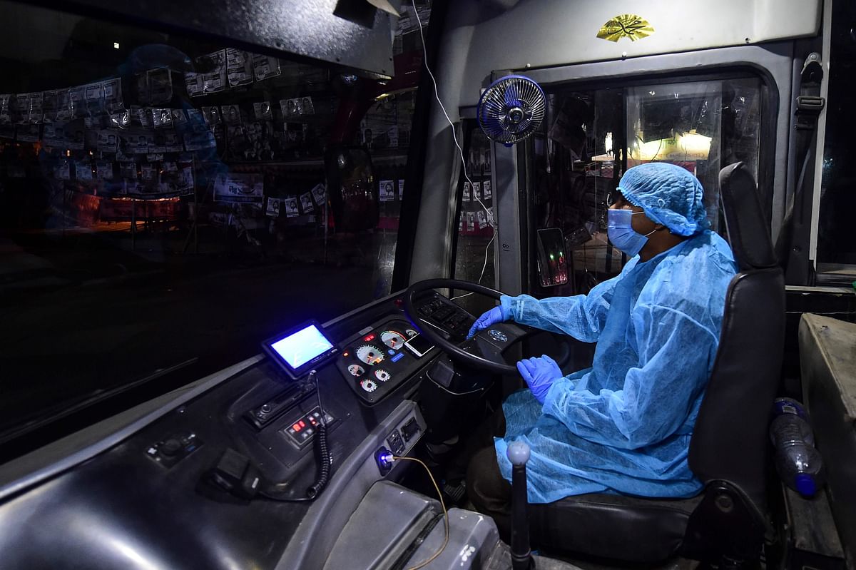 A bus driver waits to transport Bangladeshi nationals evacuated from the Chinese city of Wuhan, from the airport to a quarantine centre in Dhaka on 1 February 2020. Photo: AFP