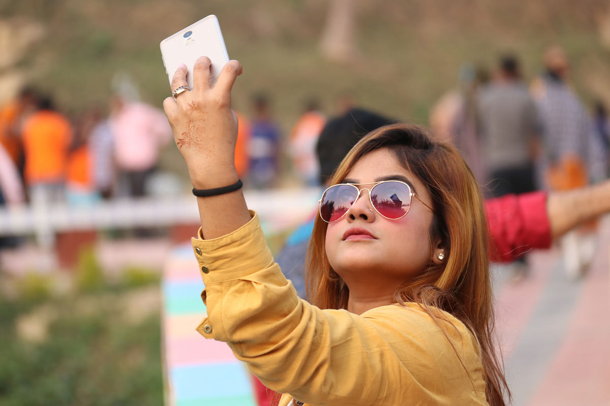 A woman takes selfie beside a lake at Khagrachhari on 2 February 2020. Photo: Nerob Chowdhury