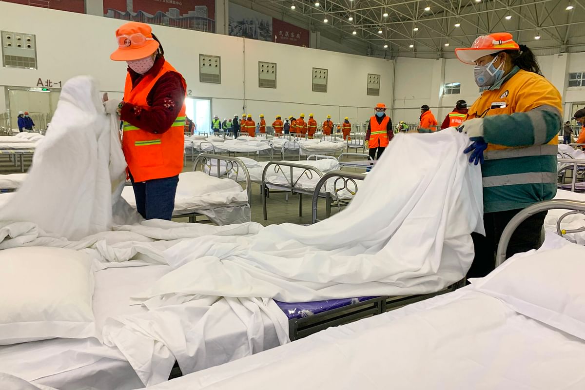Workers set up beds at an exhibition centre that was converted into a hospital in Wuhan in China`s central Hubei province on 4 February, 2020. Photo: AFP