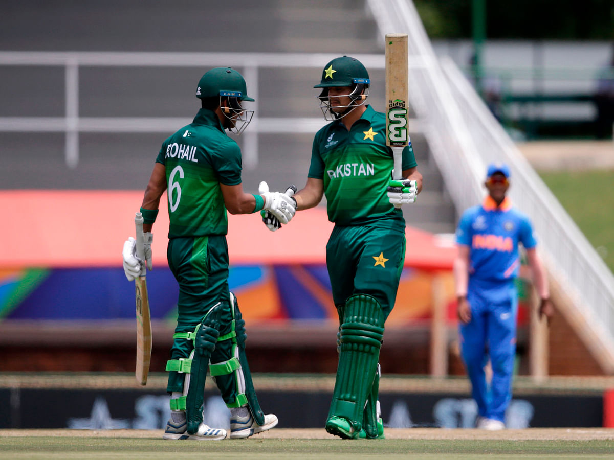 Pakistan`s Haider Ali (R) is congratulated by Pakistan`s captain Rohail Nazir after scoring a half-century (50 runs) during the semi-final of the ICC Under-19 cricket World Cup between India and Pakistan at the Senwes Park in Potchefstroom on 4 February 2020. Photo: AFP