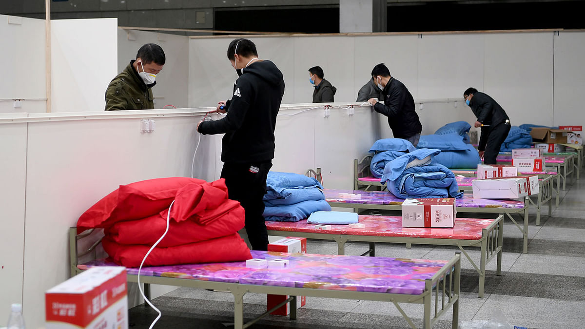Workers set up infrastructure at the Wuhan International Conference and Exhibition Center to convert it into a makeshift hospital to receive patients infected with the new coronavirus, in Wuhan, Hubei province, China on 4 February 2020. Photo: Reuters