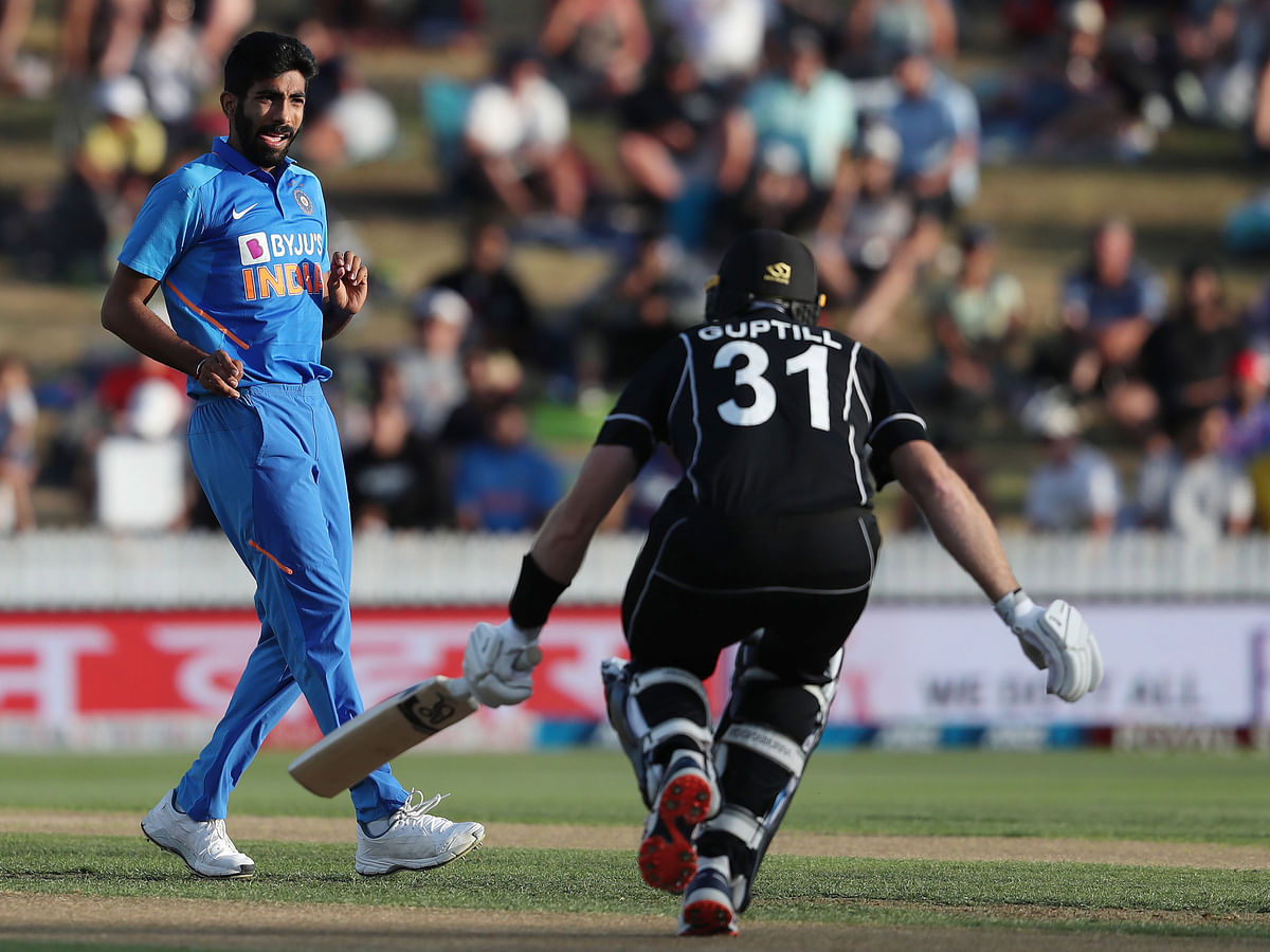 India’s Jasprit Bumrah (L) looks on after bowling to New Zealand’s Martin Guptill (R) during the first one-day international cricket match between New Zealand and India at Seddon Park in Hamilton on 5 February 2020. Photo: AFP
