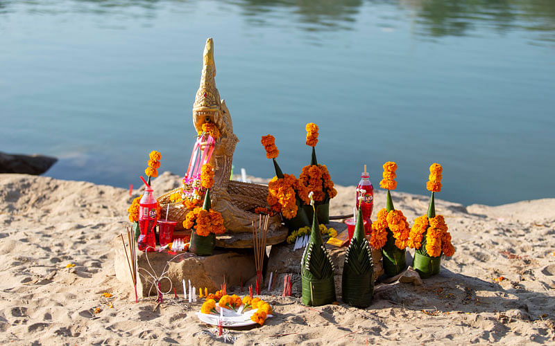 Offerings to the gods left by people praying for the raise of water level are pictured on the Mekong river bank outside Vientiane. Photo: Reuters