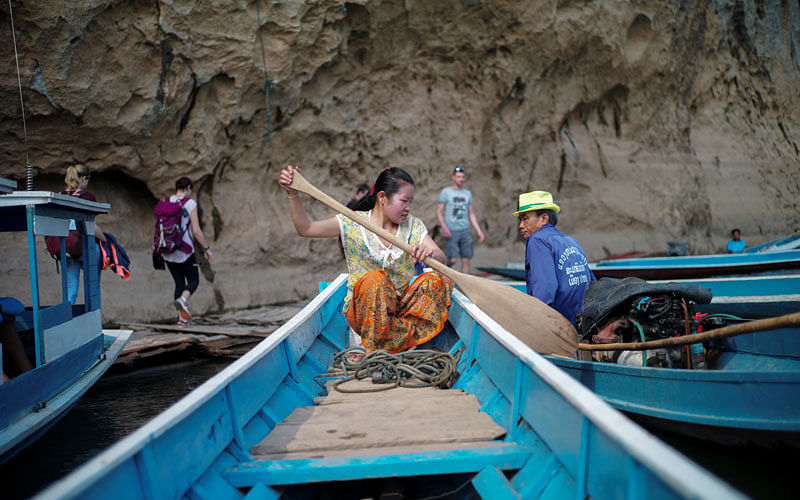 A local villager drive a boat where the future site of the Luang Prabang dam will be on the Mekong River outskirt of Luang Prabang province. Photo: Reuters