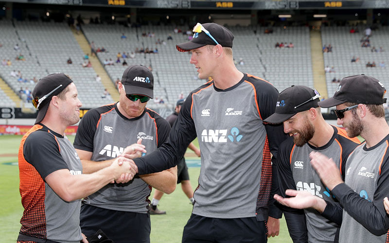 New Zealand’s Henry Nicholls (L) presents Kyle Jamieson with his cap for being selected to debut in the second One Day International cricket match between New Zealand and India at Eden Park in Auckland on 8 February 2020. Photo: AFP