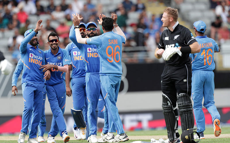 India’s Navdeep Saini ® celebrates taking the wicket of New Zealand’s Tom Blundell during the second one-day international cricket match between New Zealand and India at Eden Park in Auckland on 8 February 2020. Photo: AFP
