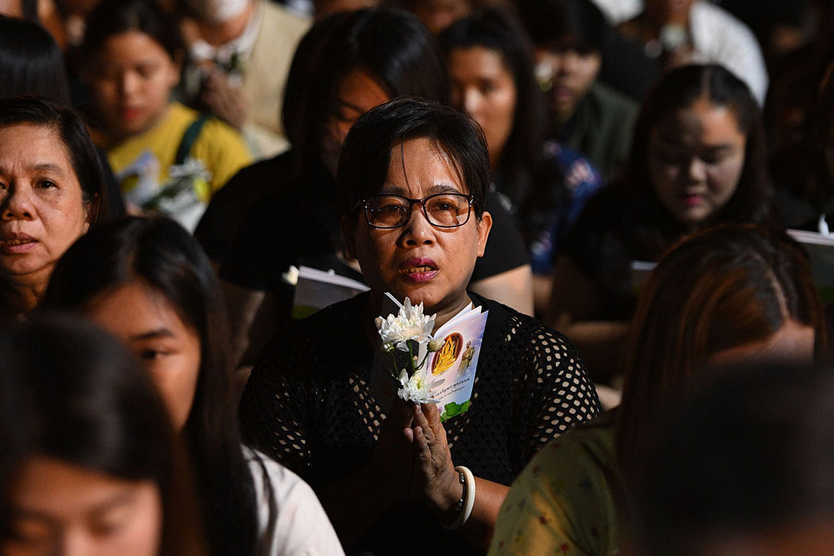 Mourners pray at a vigil for victims following a mass shooting in Nakhon Ratchasima on 9 February, 2020. Photo: AFP  Thai gunman among 27 dead in mall shooting