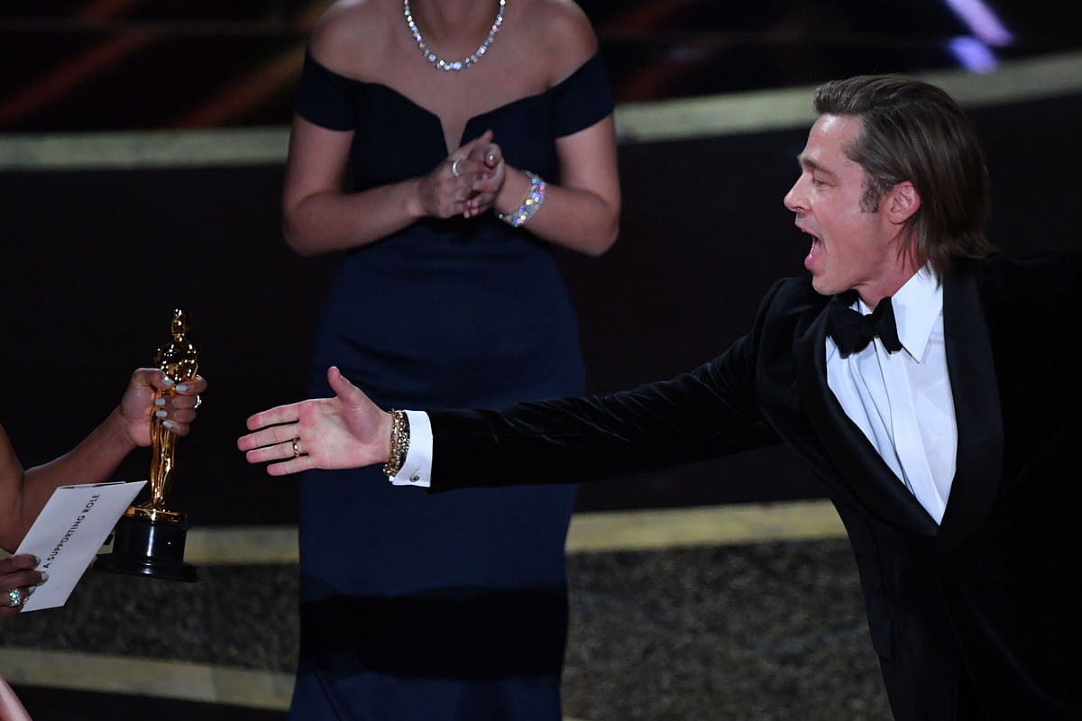 US actor Brad Pitt accepts the award for Best Actor in a Supporting Role for `Once upon a Time...in Hollywood` from US actress Regina King (L) during the 92nd Oscars at the Dolby Theatre in Hollywood, California on 9 February 2020. Photo: AFP