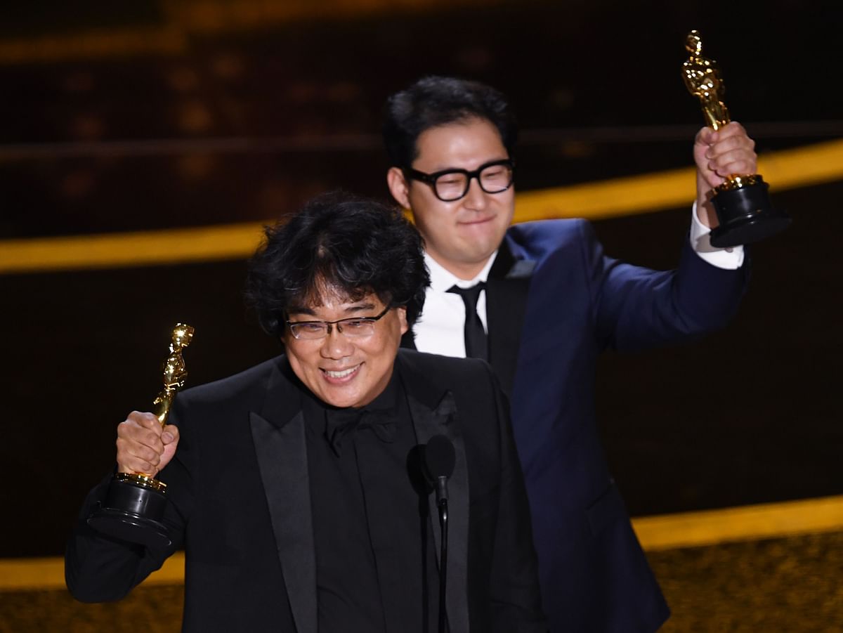 Bong Joon-ho and Han Jin-won accept the Writing - Original Screenplay - award for `Parasite` onstage during the 92nd Annual Academy Awards at Dolby Theatre on 9 February in Hollywood, California. Photo: AFP