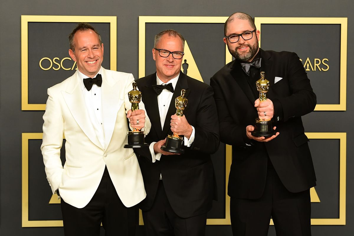US producer Jonas Rivera, Mark Nielsen and Josh Cooley pose in the press room with the award for Best Animated Feature Film for `Toy Story 4` during the 92nd Oscars at the Dolby Theater in Hollywood, California on 9 February. Photo: AFP