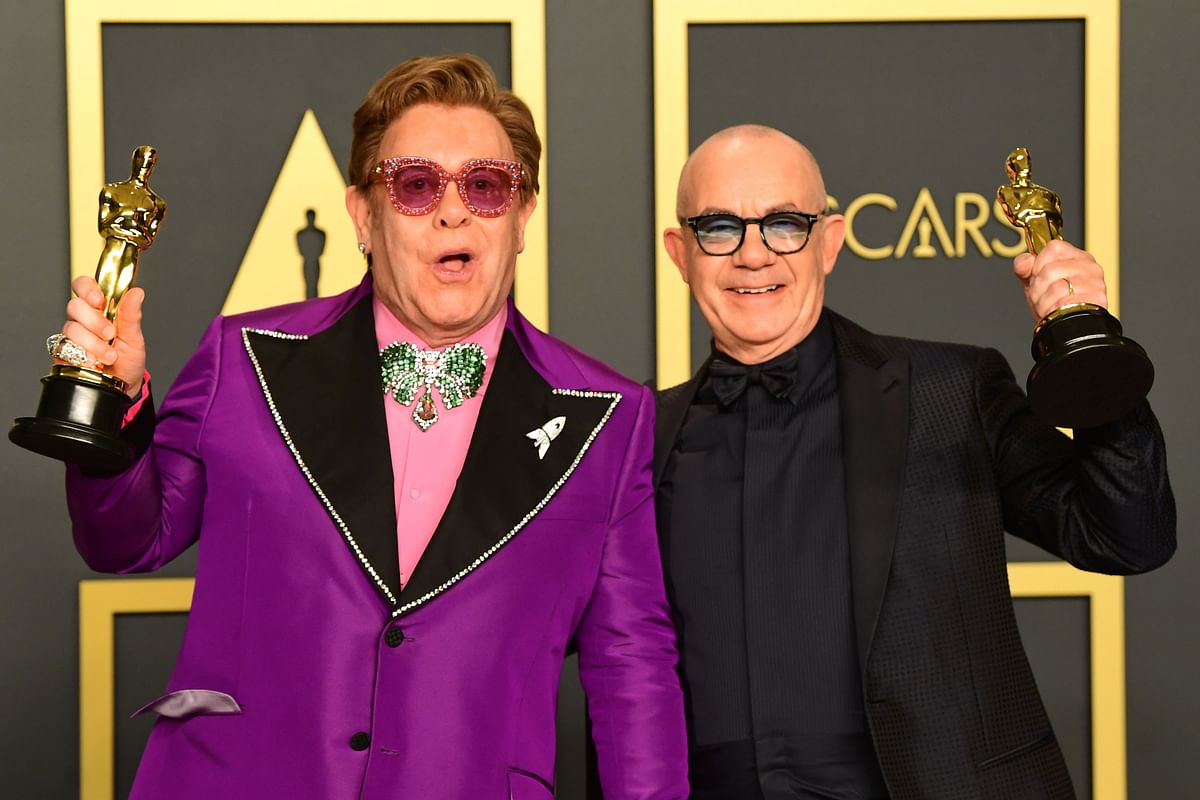 British singer-songwriter Elton John (L) and British lyricist Bernie Taupin pose in the press room with the Oscar for Best Original Song for `(I`m Gonna) Love Me Again, `Rocketman`` during the 92nd Oscars at the Dolby Theater in Hollywood, California on 9 February 2020. Photo: AFP