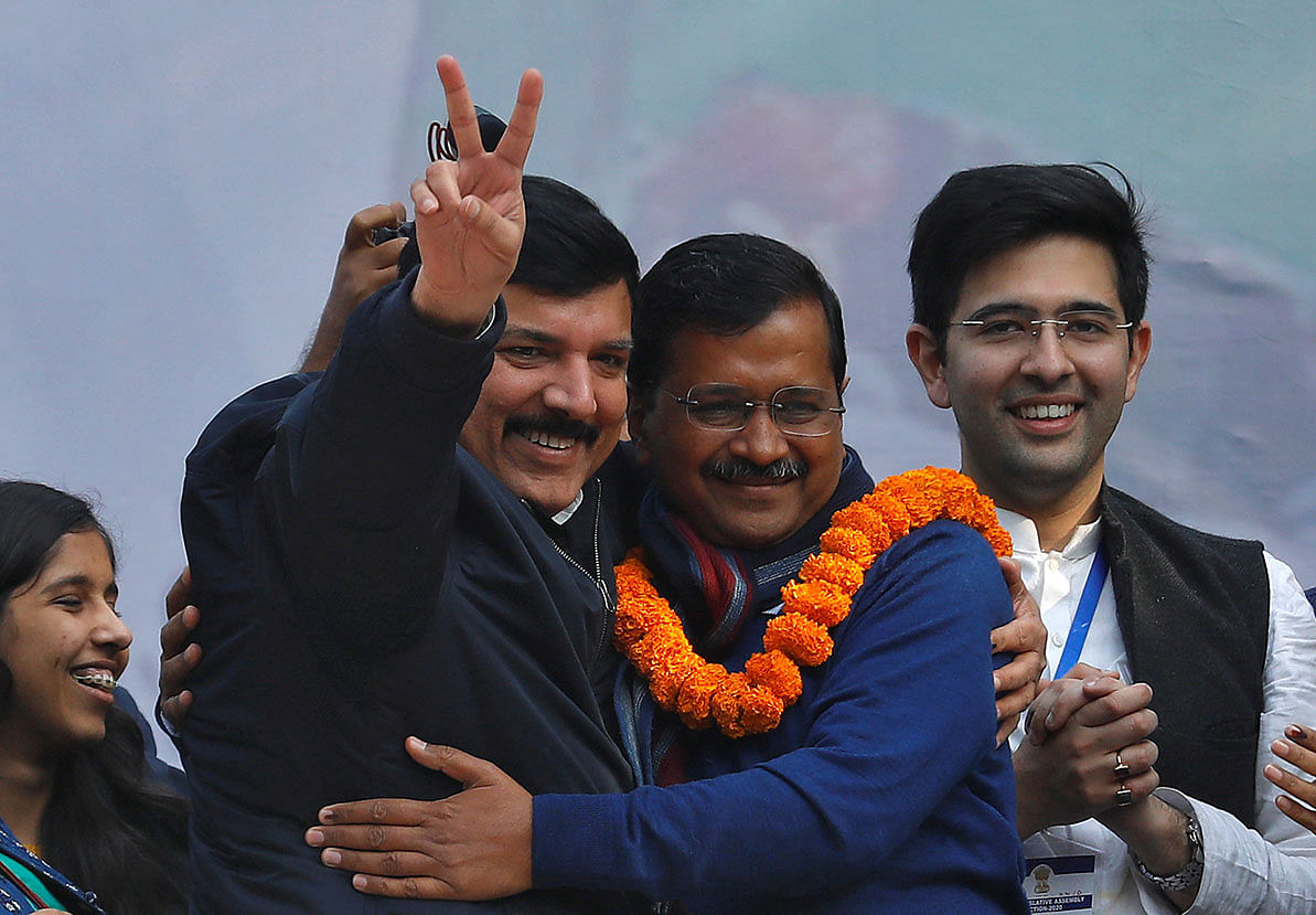 Delhi chief minister and leader of Aam Aadmi Party (AAP) Arvind Kejriwal is greeted by Sanjay Singh, a member of parliament, as Raghav Chadha, one of the party`s candidates, looks on during celebrations at the party headquarters in New Delhi, India, on 11 February 2020. Photo: Reuters
