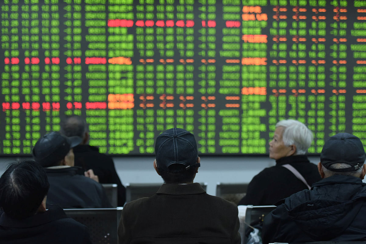 Investors sit in front of a board showing stock information at a brokerage house on the first day of trade in China since the Lunar New Year, in Hangzhou, Zhejiang province, China February 3, 2020.Reuters File Photo