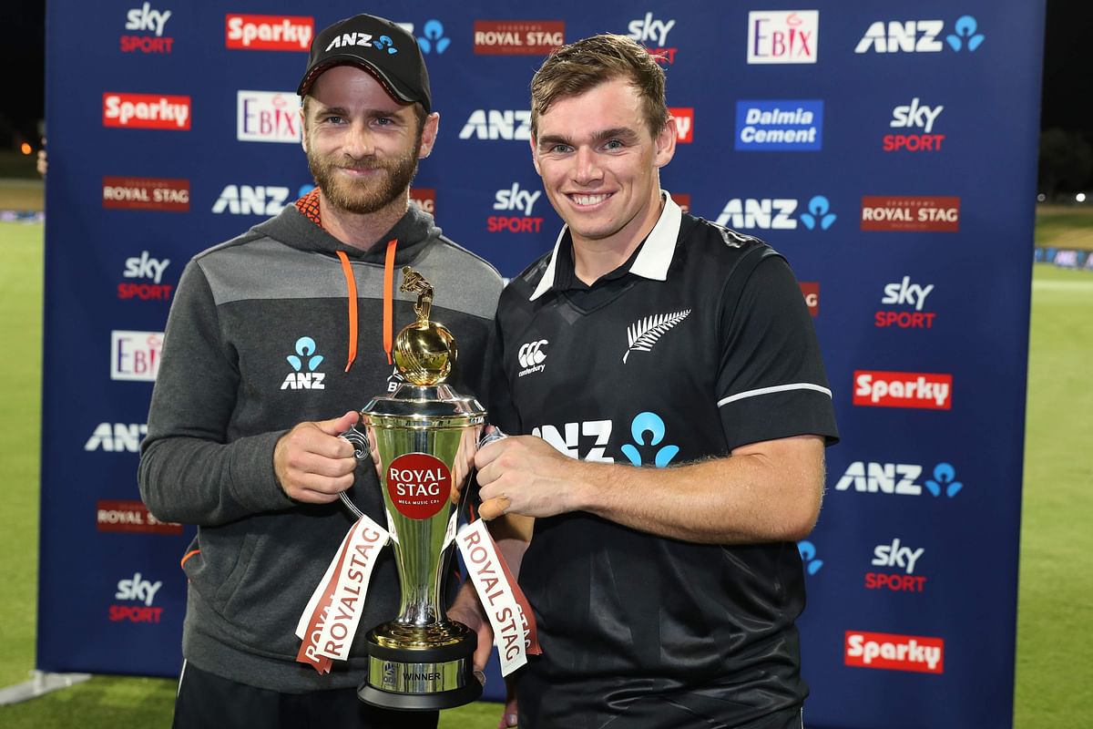 New Zealand’s Kane Williamson (L) and Tom Latham celebrate with the trophy after victory during the third one-day international cricket match between New Zealand and India at the Bay Oval in Mount Maunganui on 11 February 2020. Photo: AFP