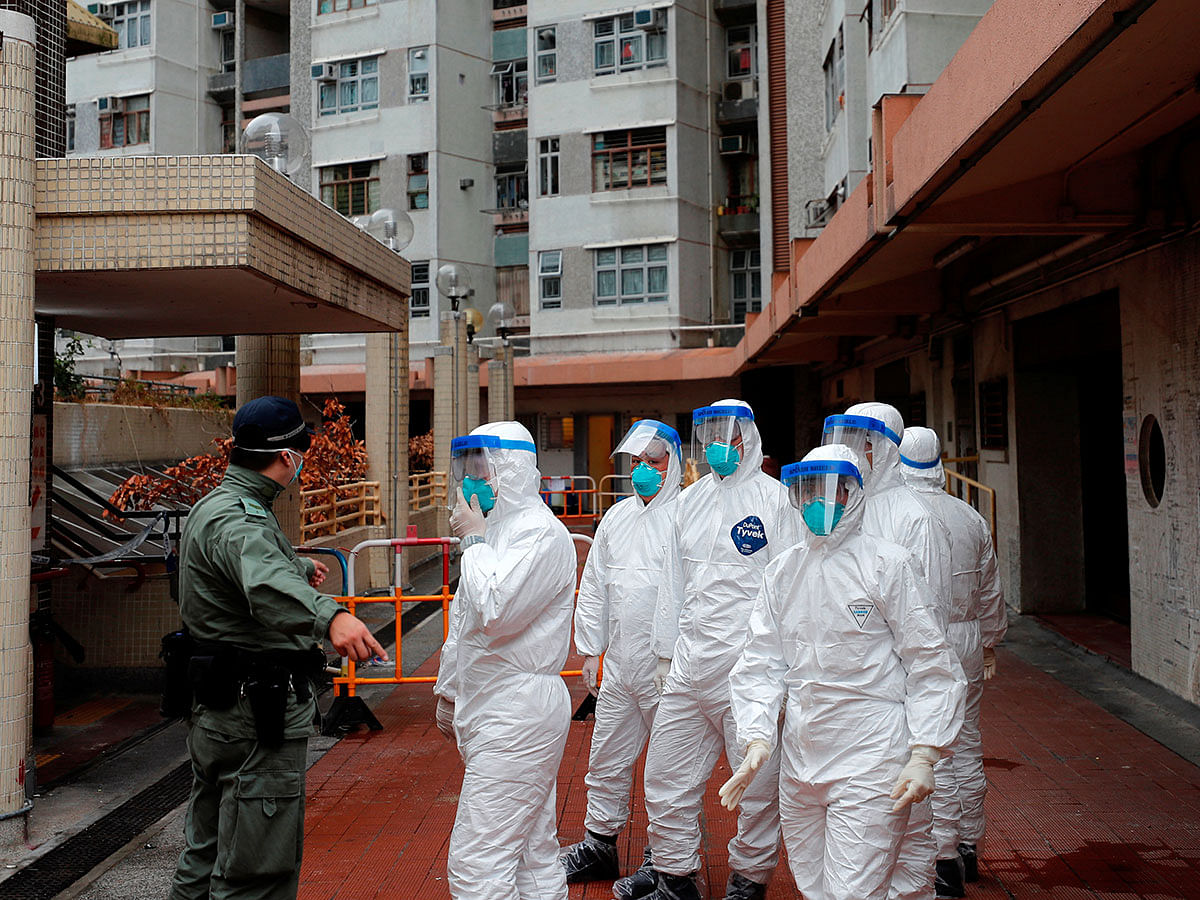 Police in protective gear wait to evacuate residents from a public housing building, following the outbreak of the novel coronavirus, in Hong Kong, China on 11 February 2020. Photo: Reuters